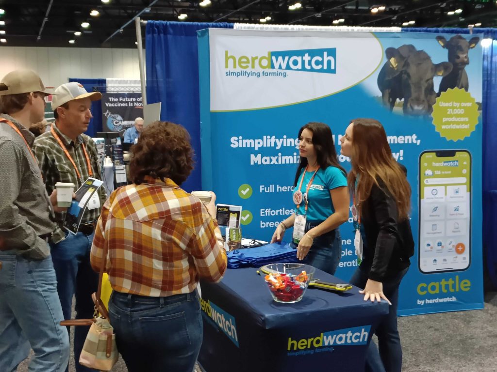 women at booth talking to farmers