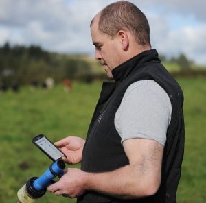 Liam O’Keeffe farmer using Herdwatch app in field