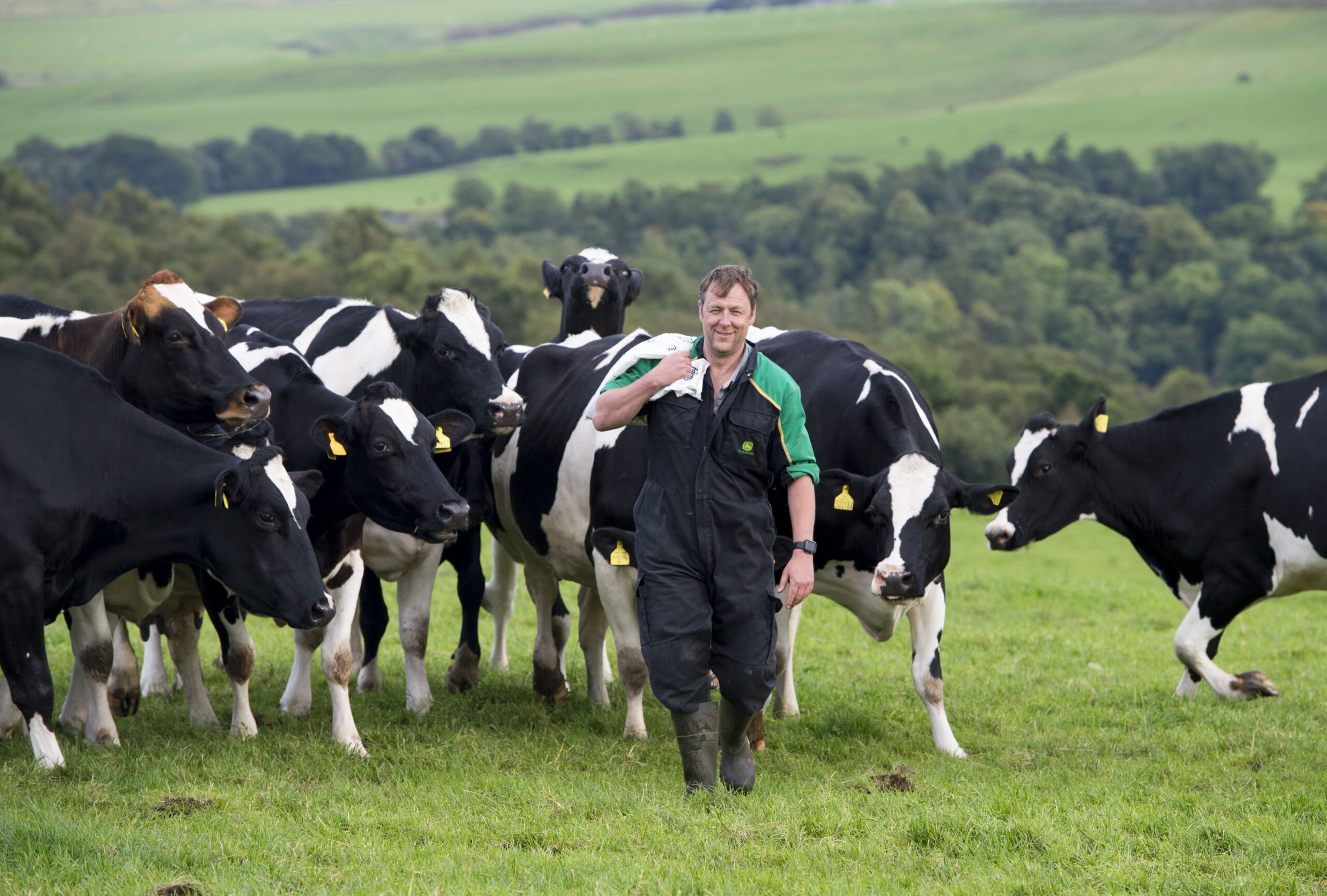 Andrew Paterson dairy farmer in field with cows