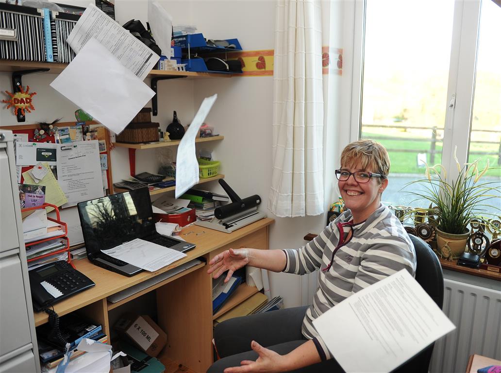 woman in office with paperwork Yvonne Hoban