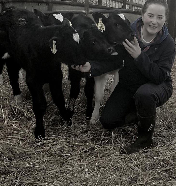 Helen farmer in shed with calves